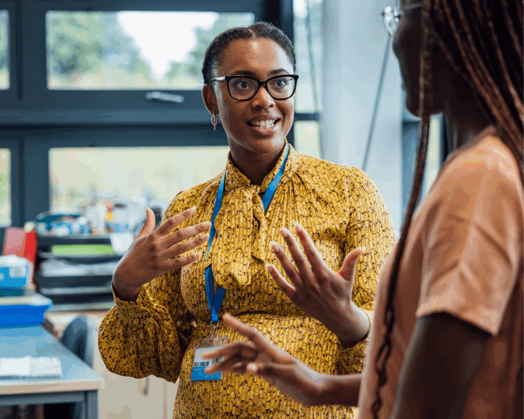 Image of two teachers standing together in discussion.