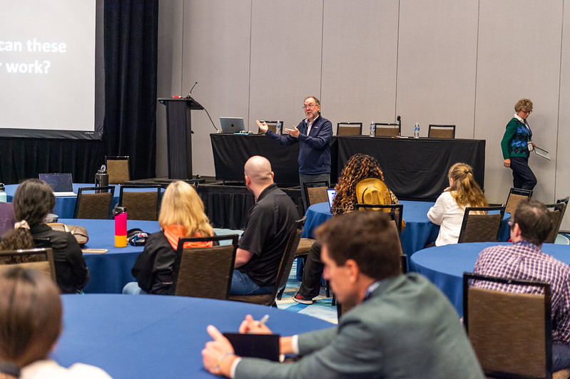 Photo from the back of a filled conference room at OLC Accelerate.