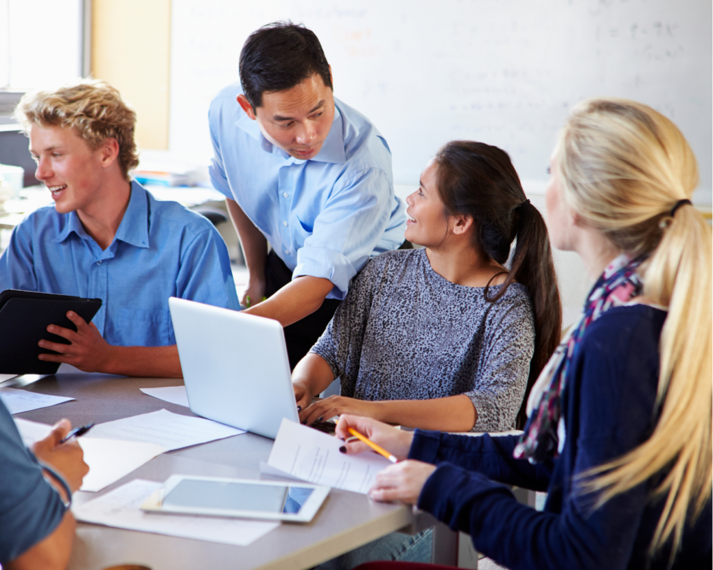 Bright photo of a group of young professionals collaborating around a shared table.