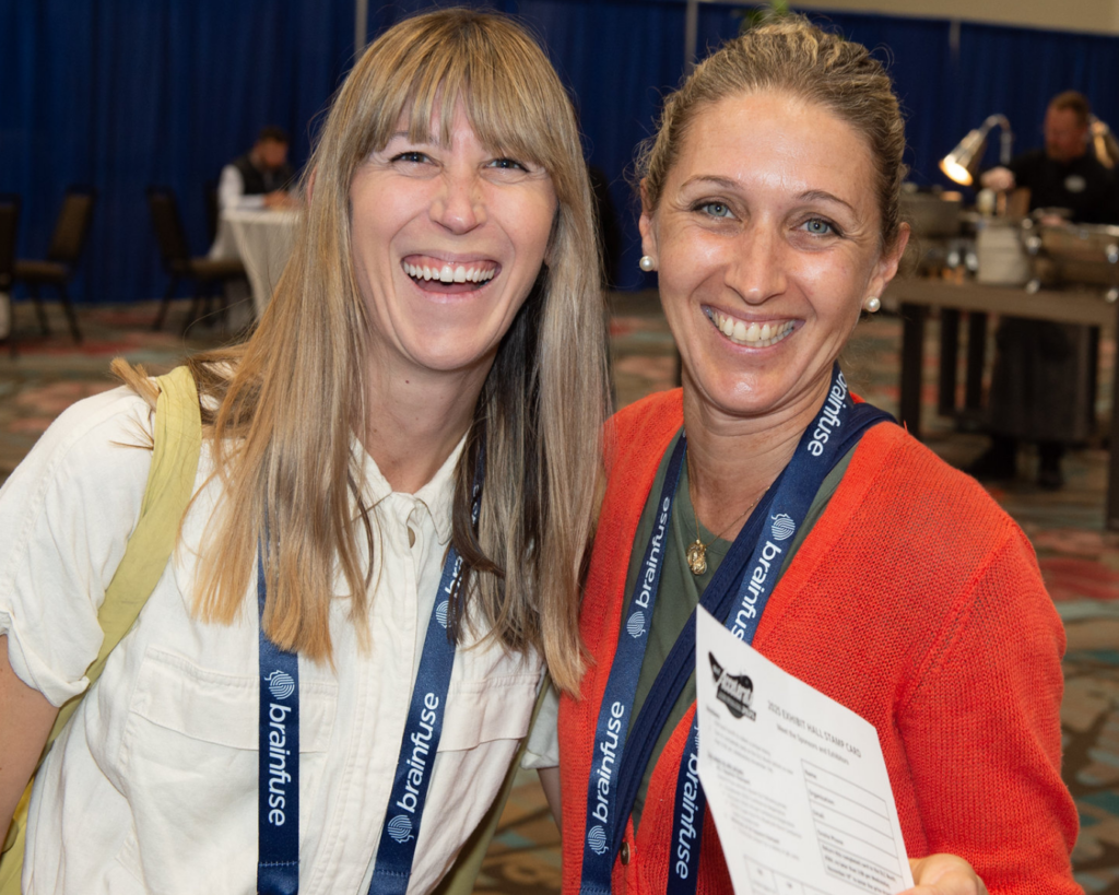 Photo of two women smiling and posing together at OLC Accelerate